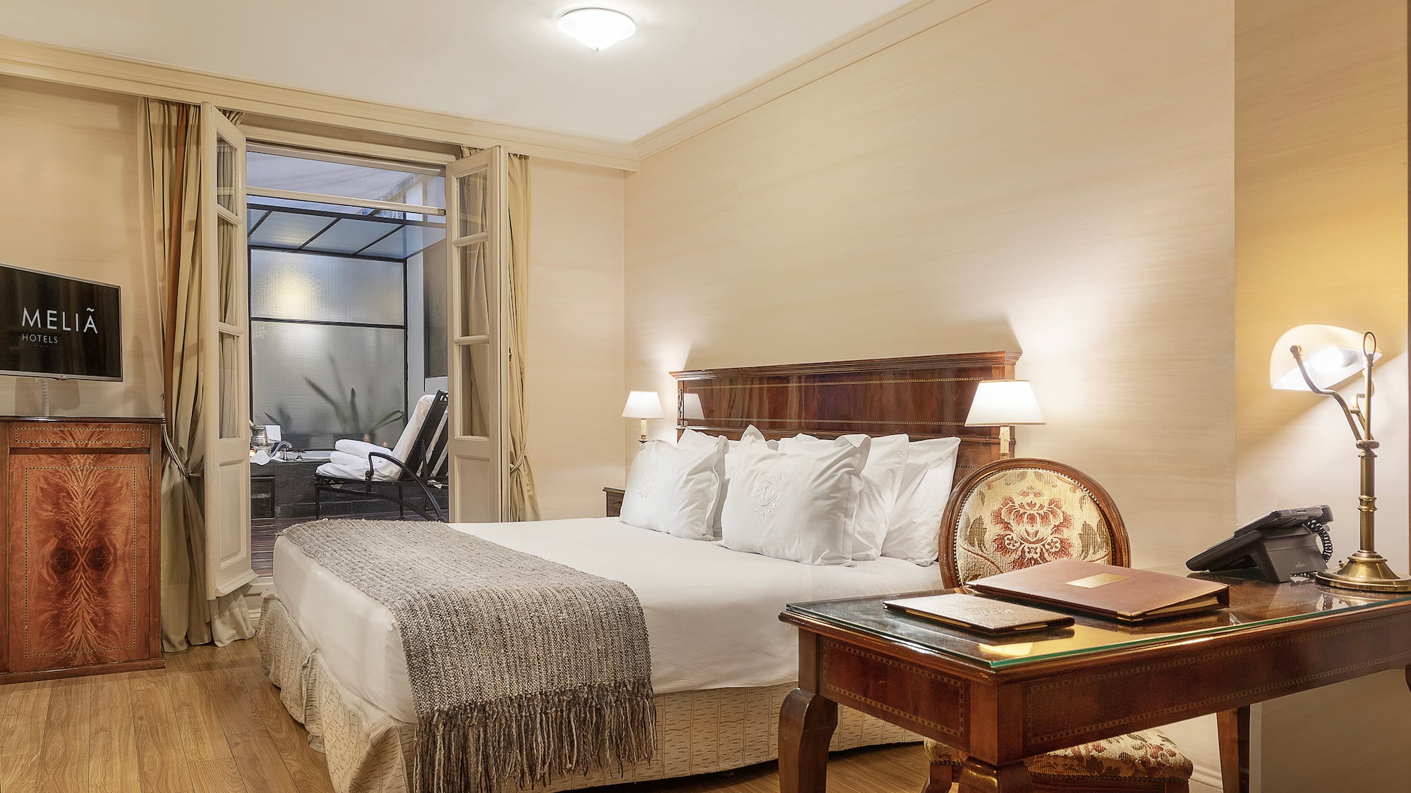 a bedroom with a desk and a bed