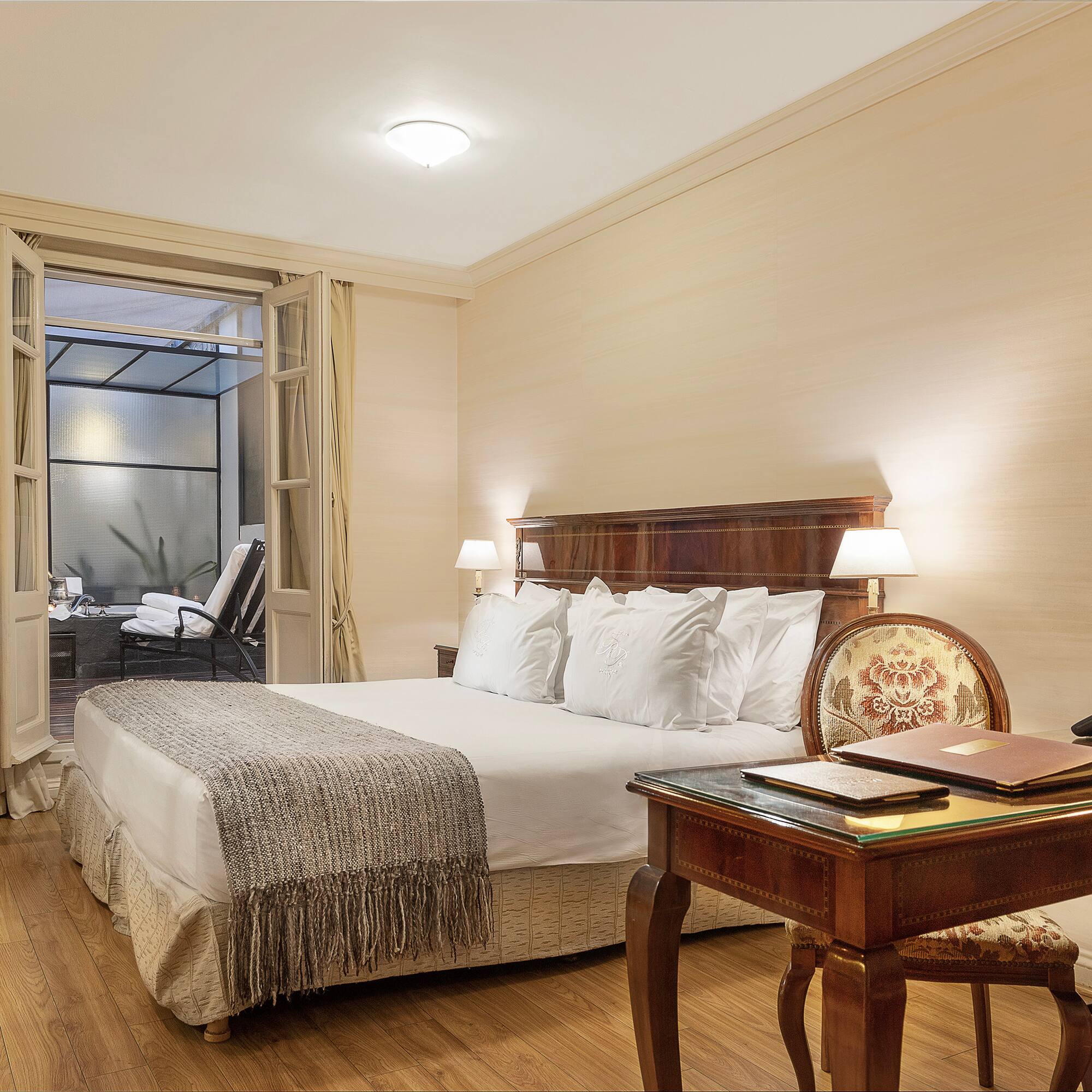 a bedroom with a desk and a bed