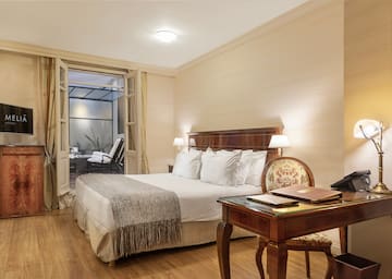 a bedroom with a desk and a bed