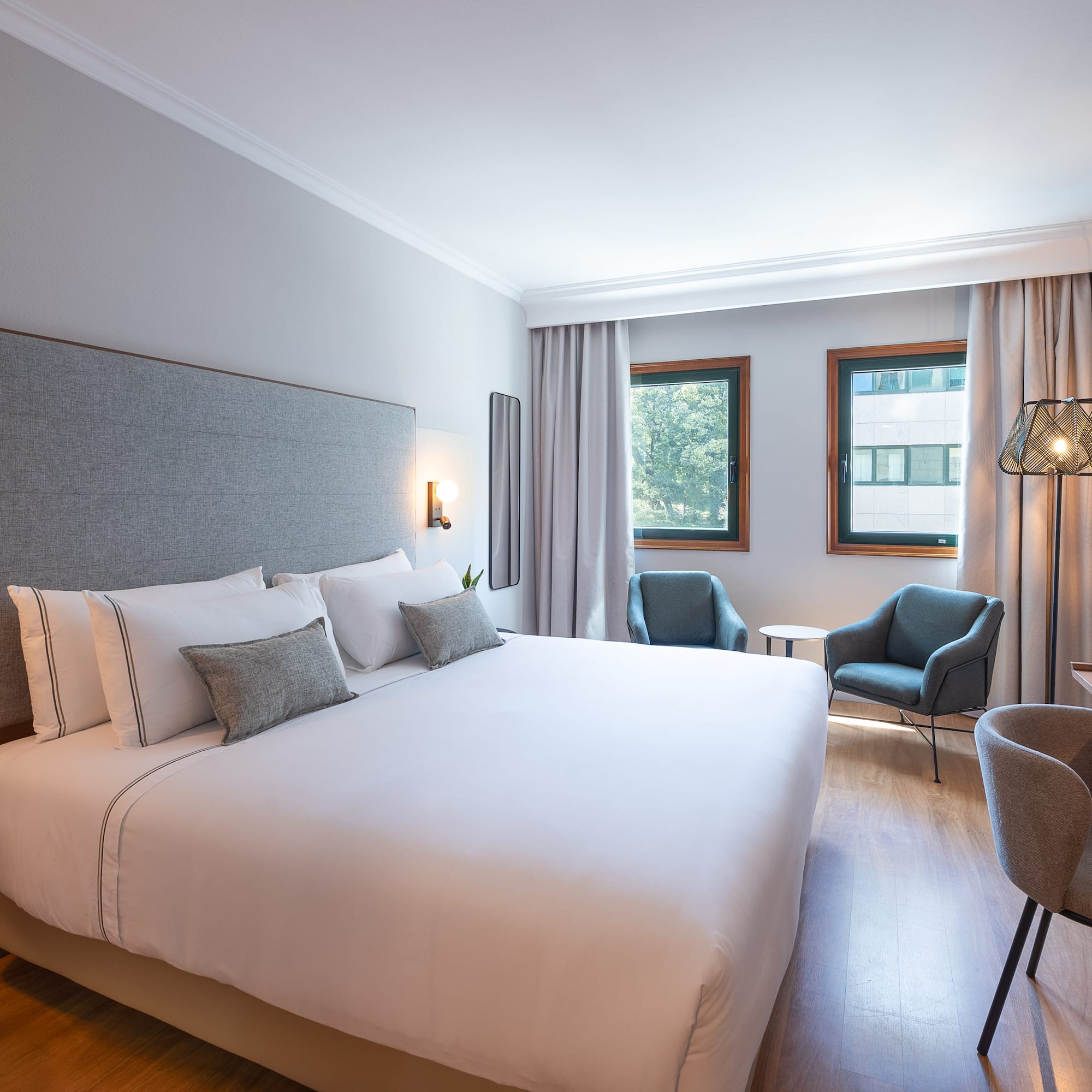 a bedroom with a bed and chairs