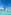 Sunny resort pool with blue water, palm trees, and lounge chairs.