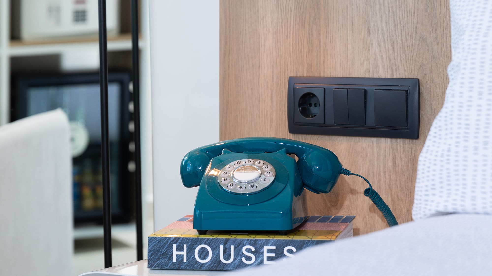 a telephone on a book on a nightstand