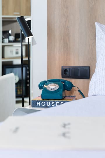 a telephone on a book on a nightstand