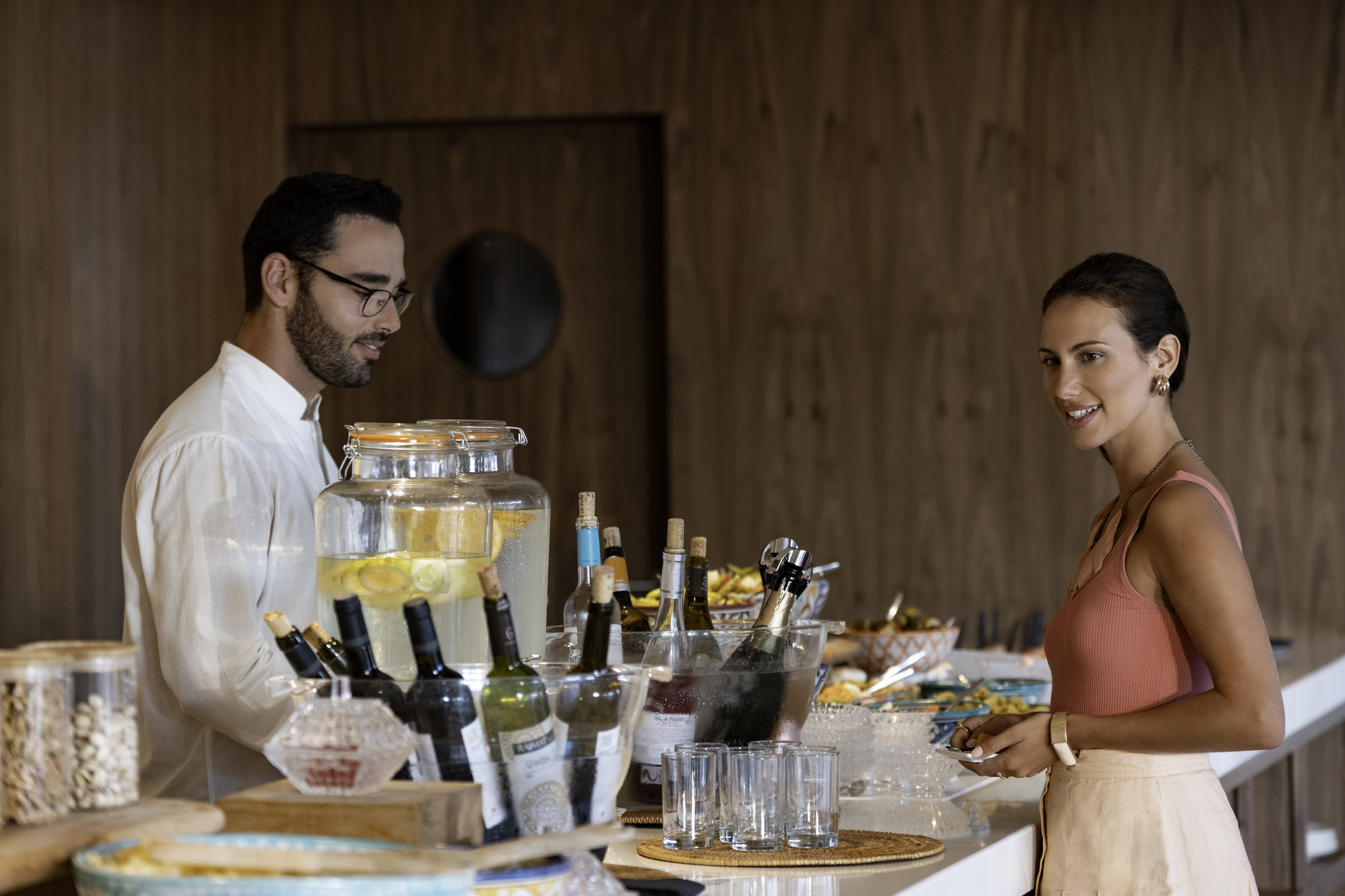 a man and woman standing at a buffet table