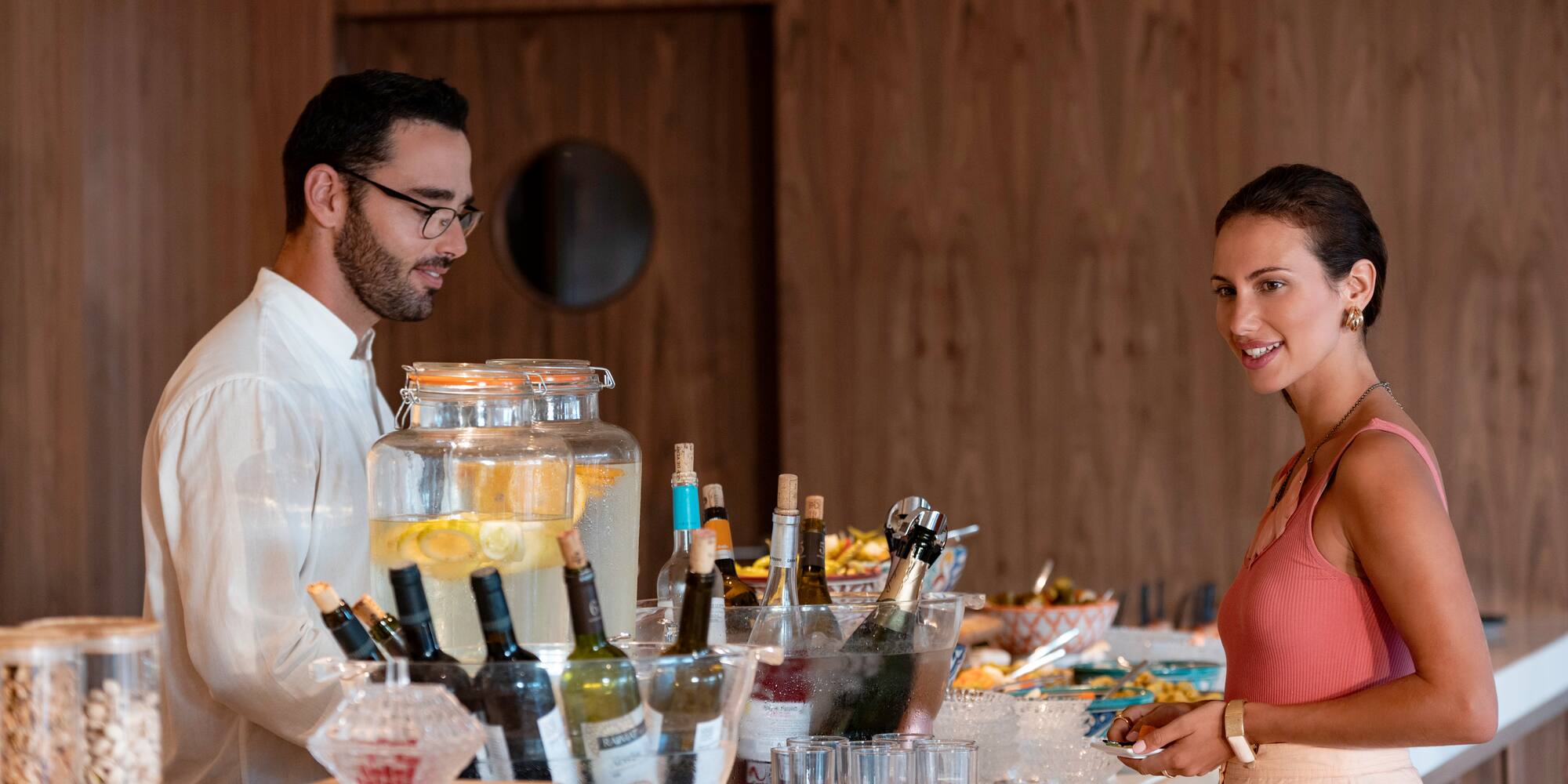 a man and woman standing at a buffet table