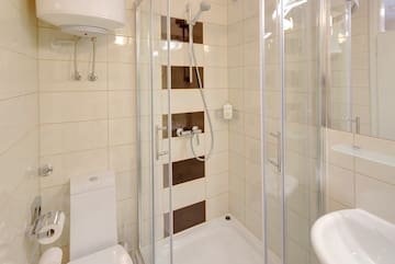 a bathroom with a shower and toilet