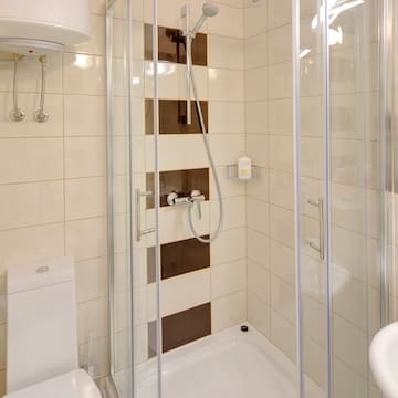 a bathroom with a shower and toilet