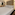 Modern hotel suite with large bed, sitting area, and bright open bathroom.