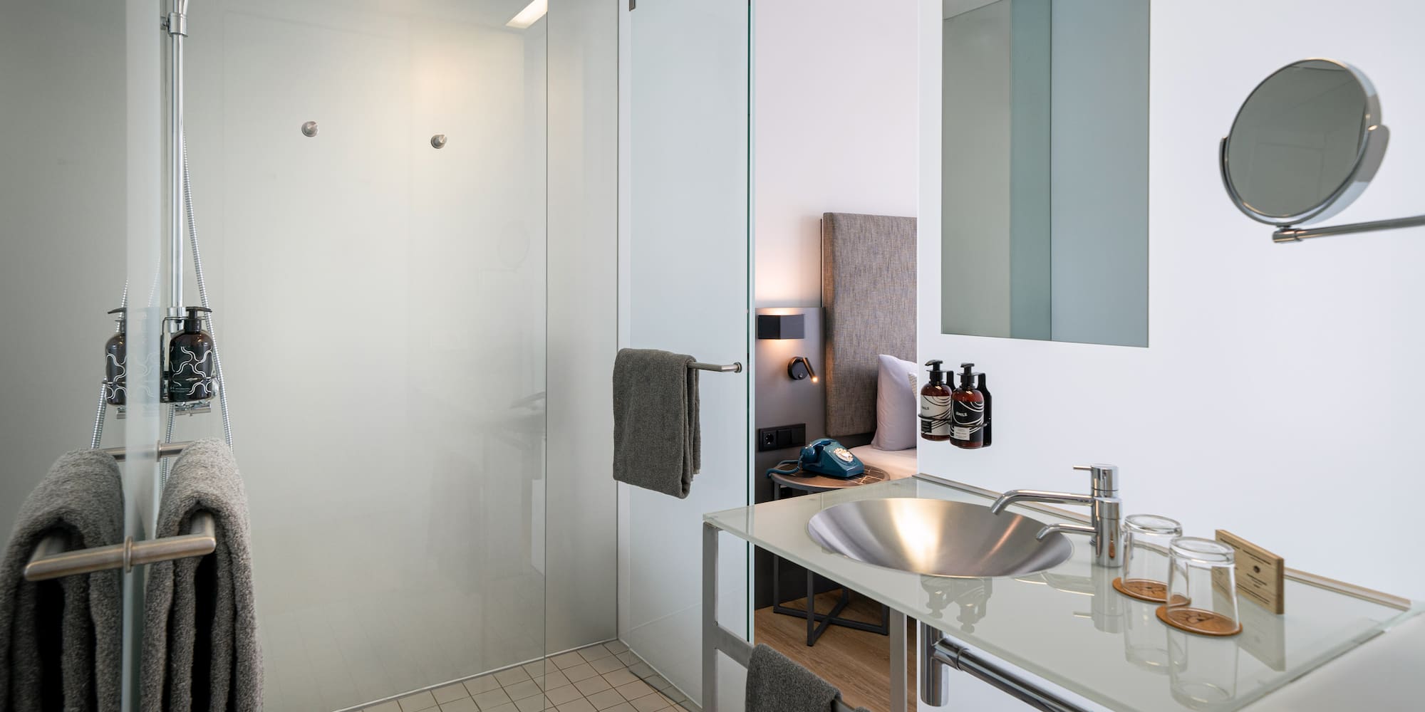 a bathroom with a glass shower and sink