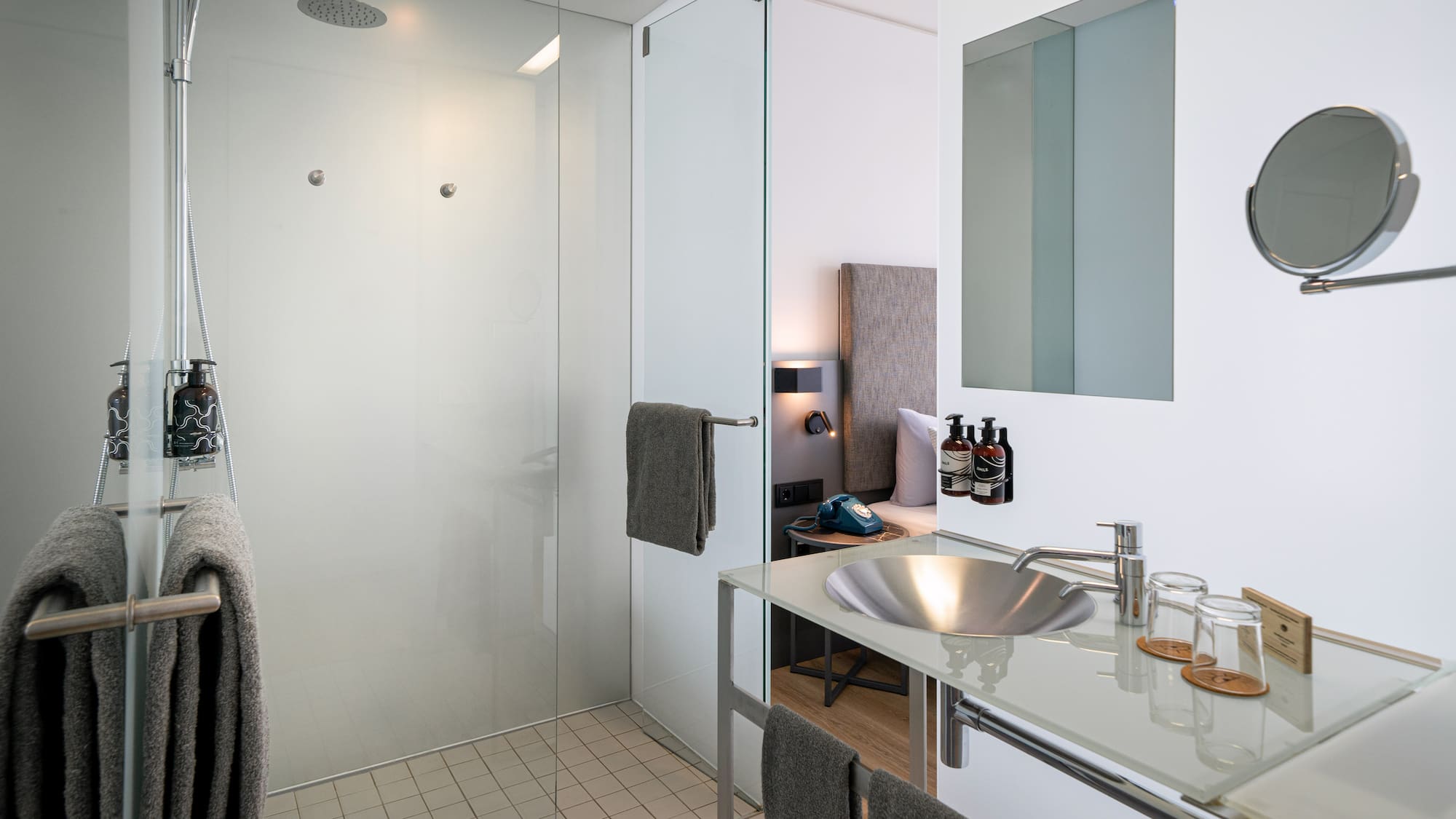 a bathroom with a glass shower and sink