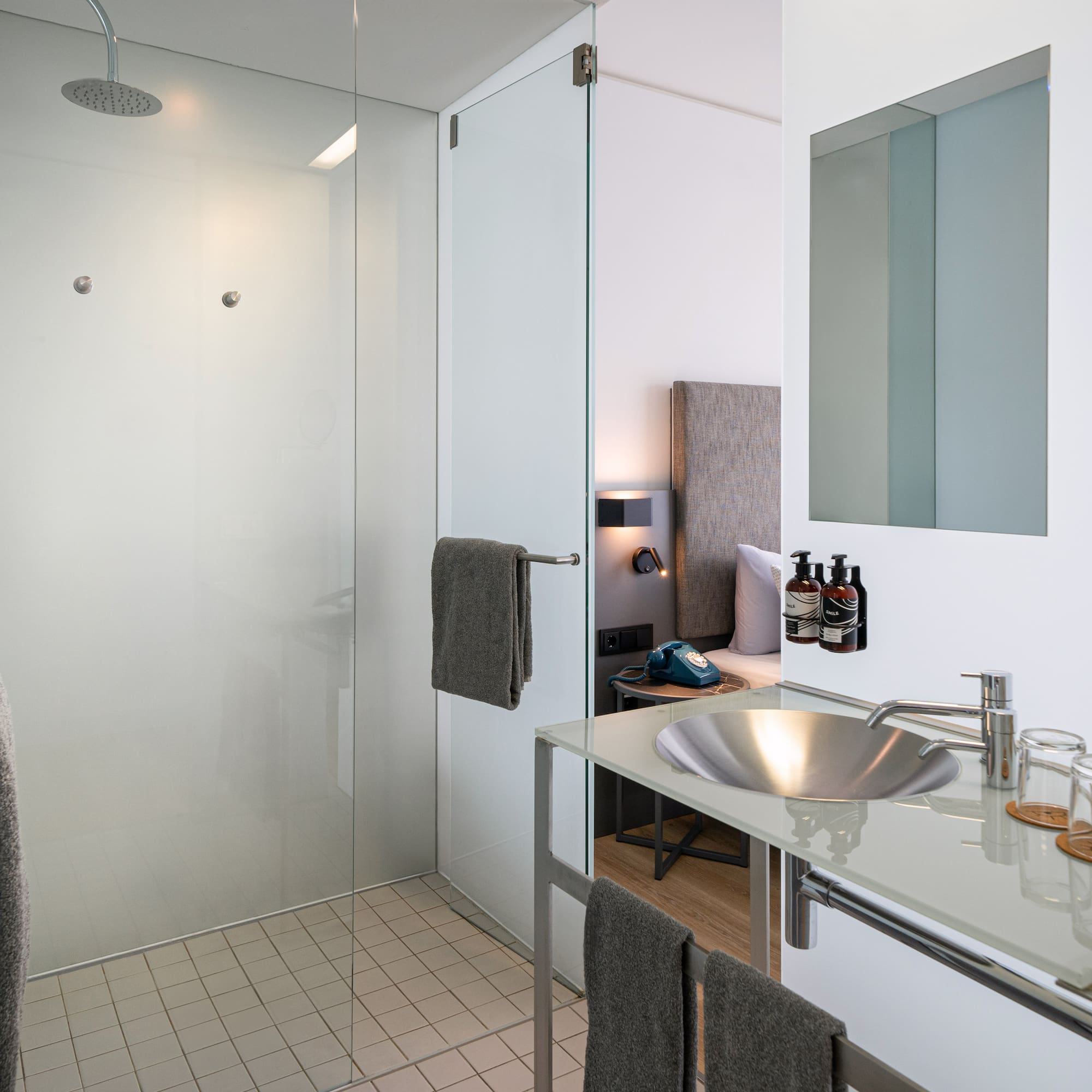 a bathroom with a glass shower and sink