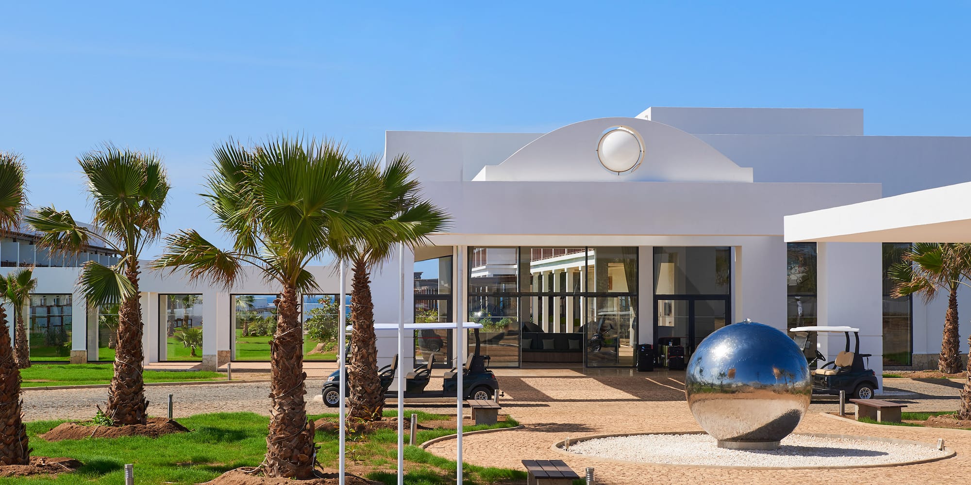 a building with a mirror ball in front of it