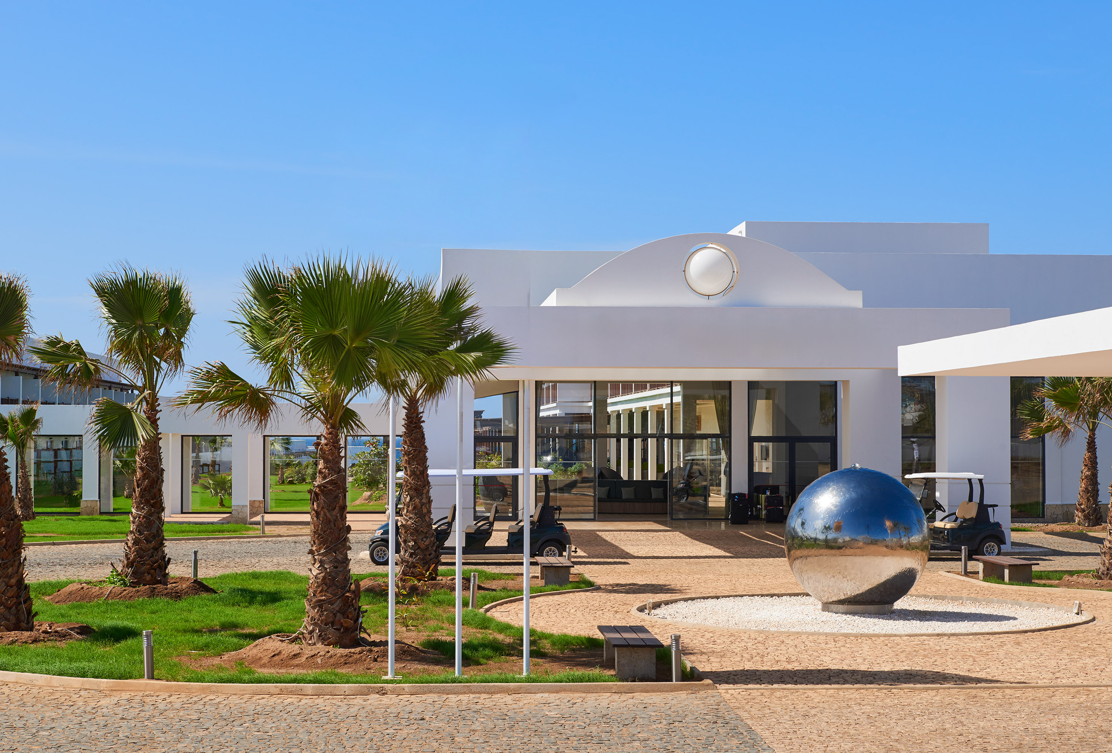 a building with a mirror ball in front of it