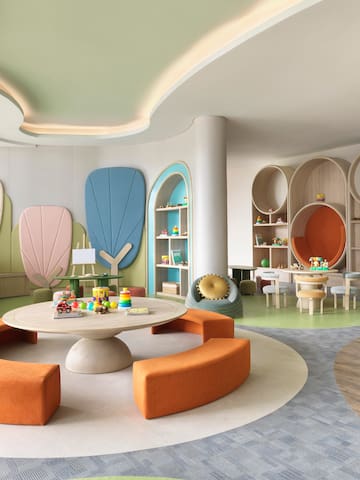 a room with a round table and colorful chairs