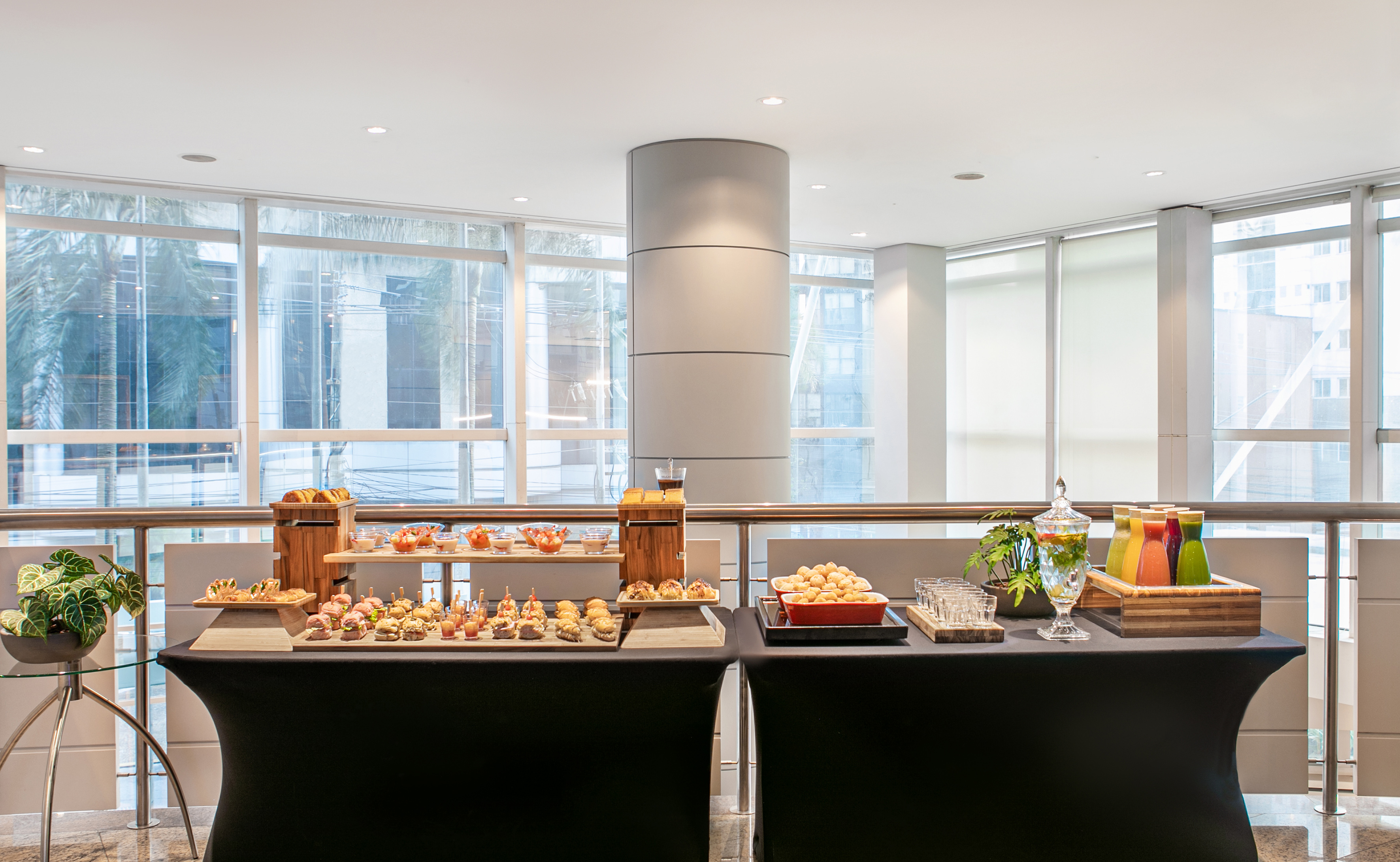 Buffet catering with appetizers, finger foods, and drinks in a modern event space.