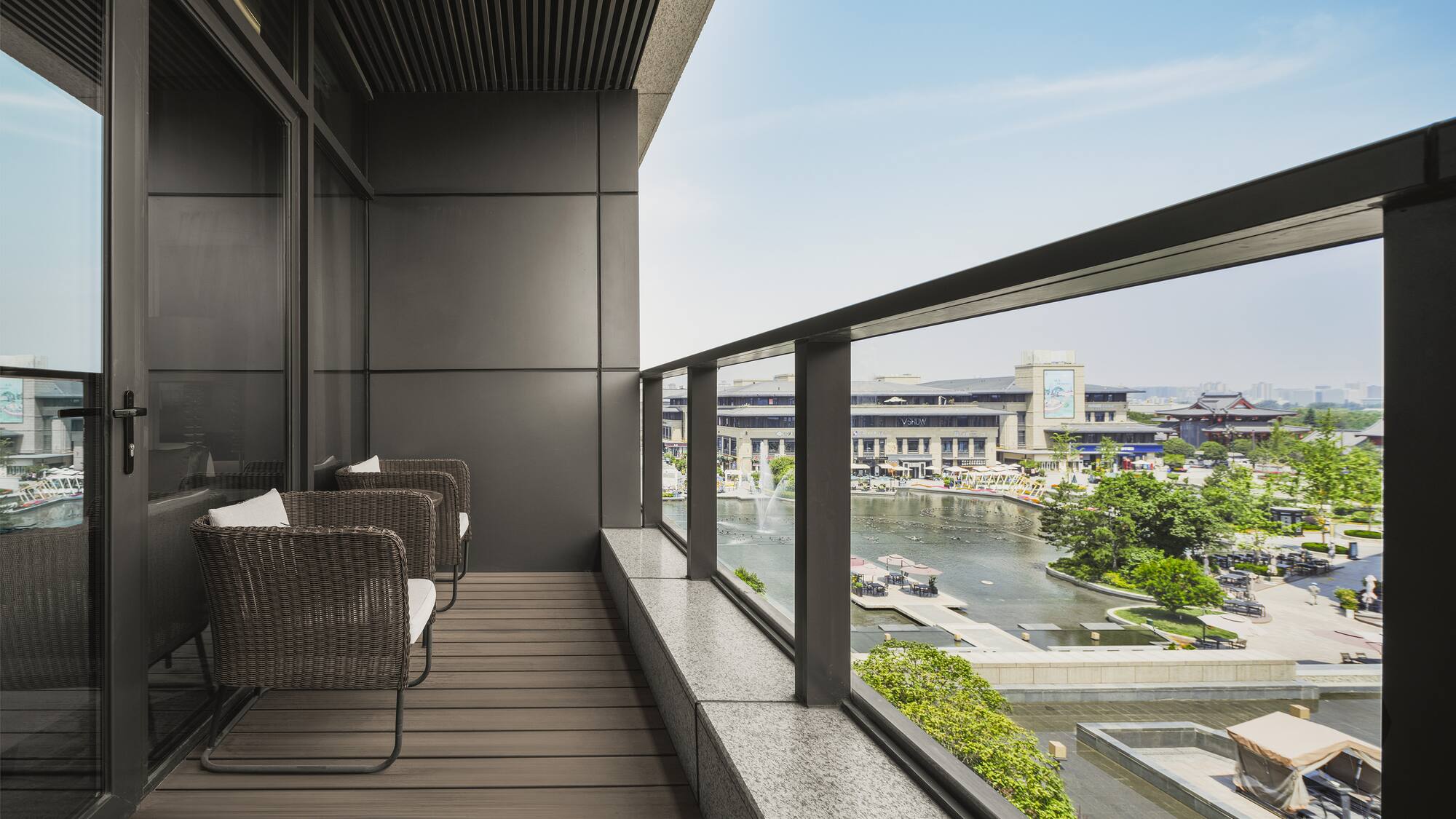 a balcony with chairs and a view of a river and city