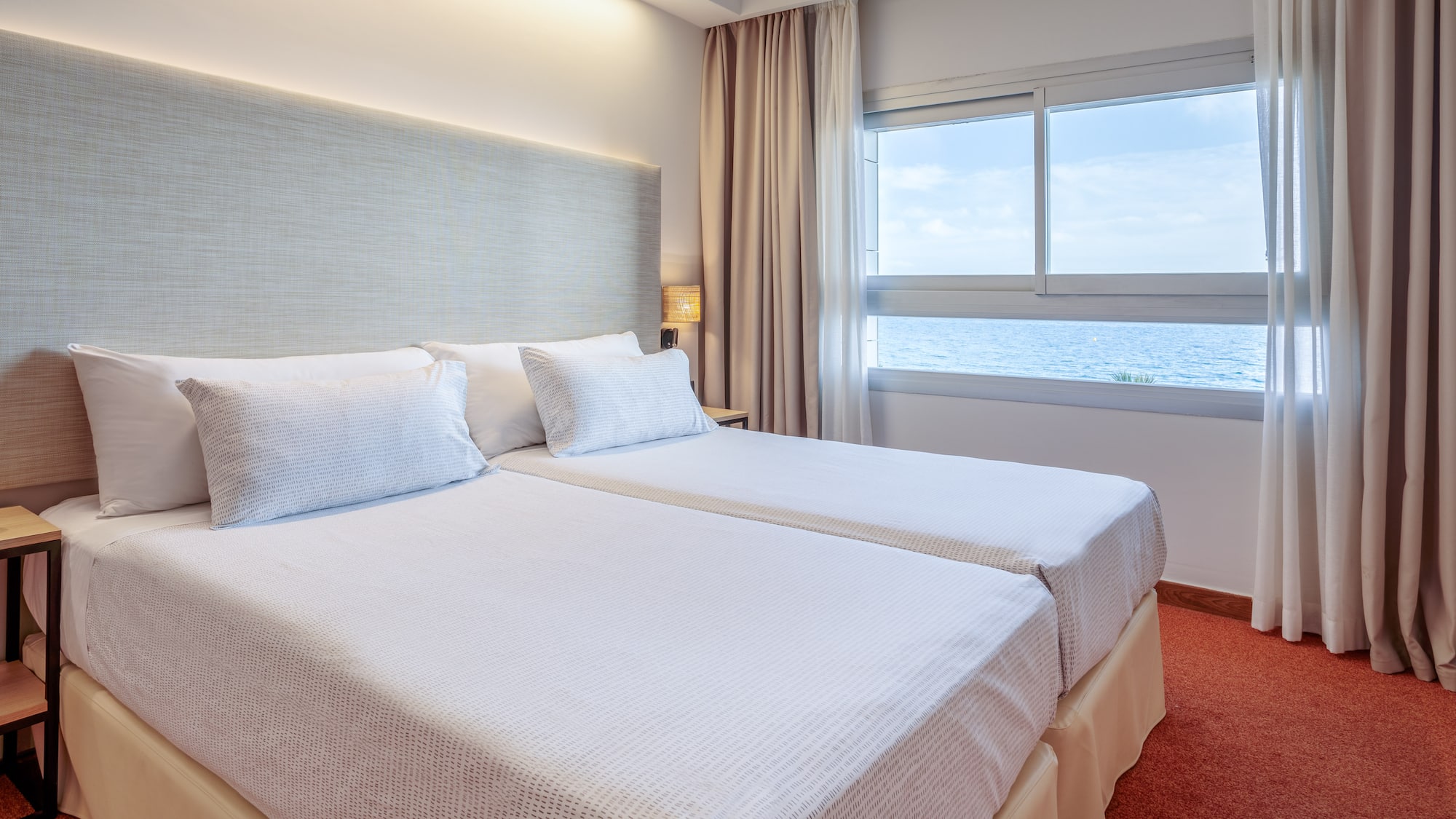 a room with two beds and a window