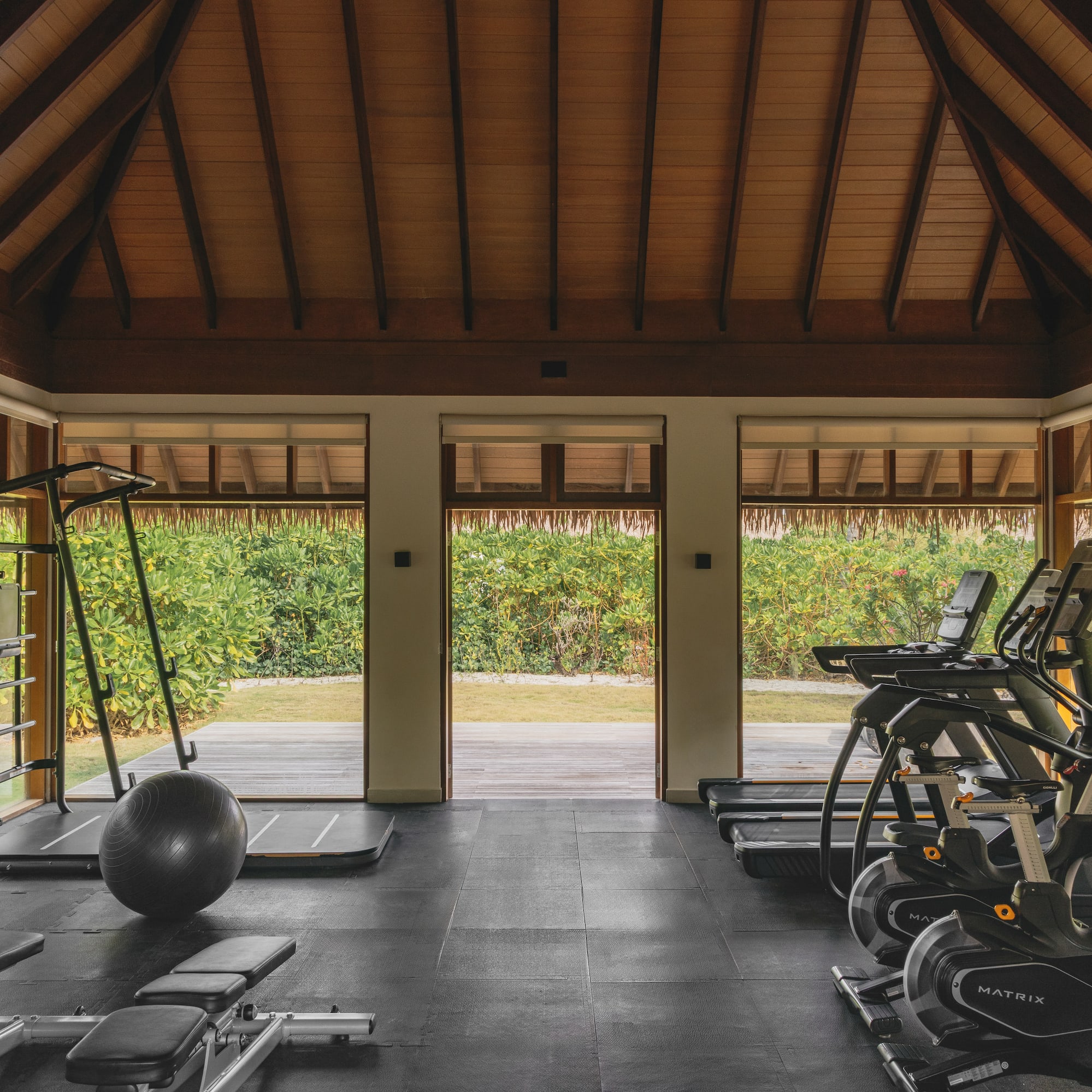 a room with exercise equipment and a large window