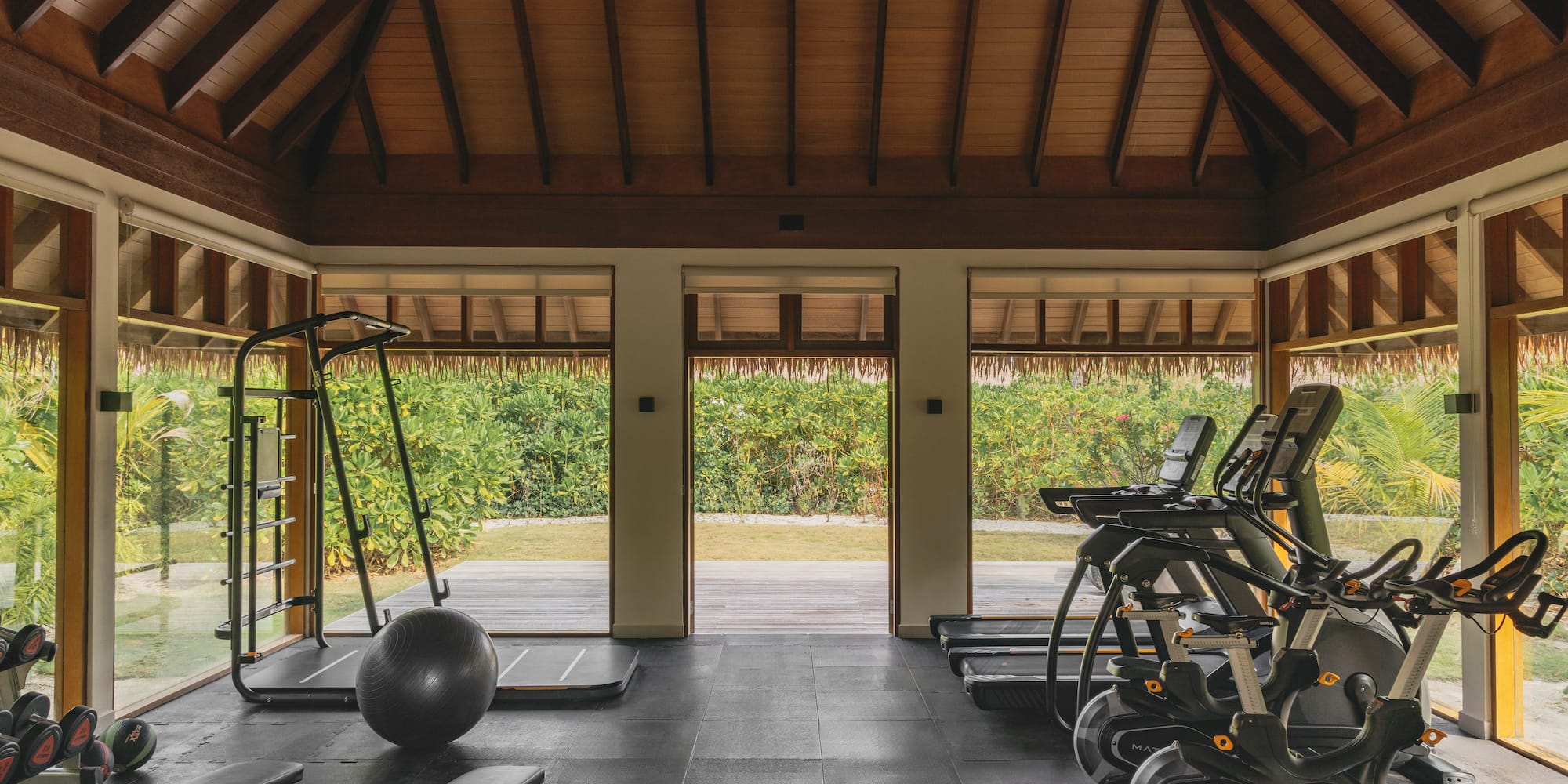 a room with exercise equipment and a large window