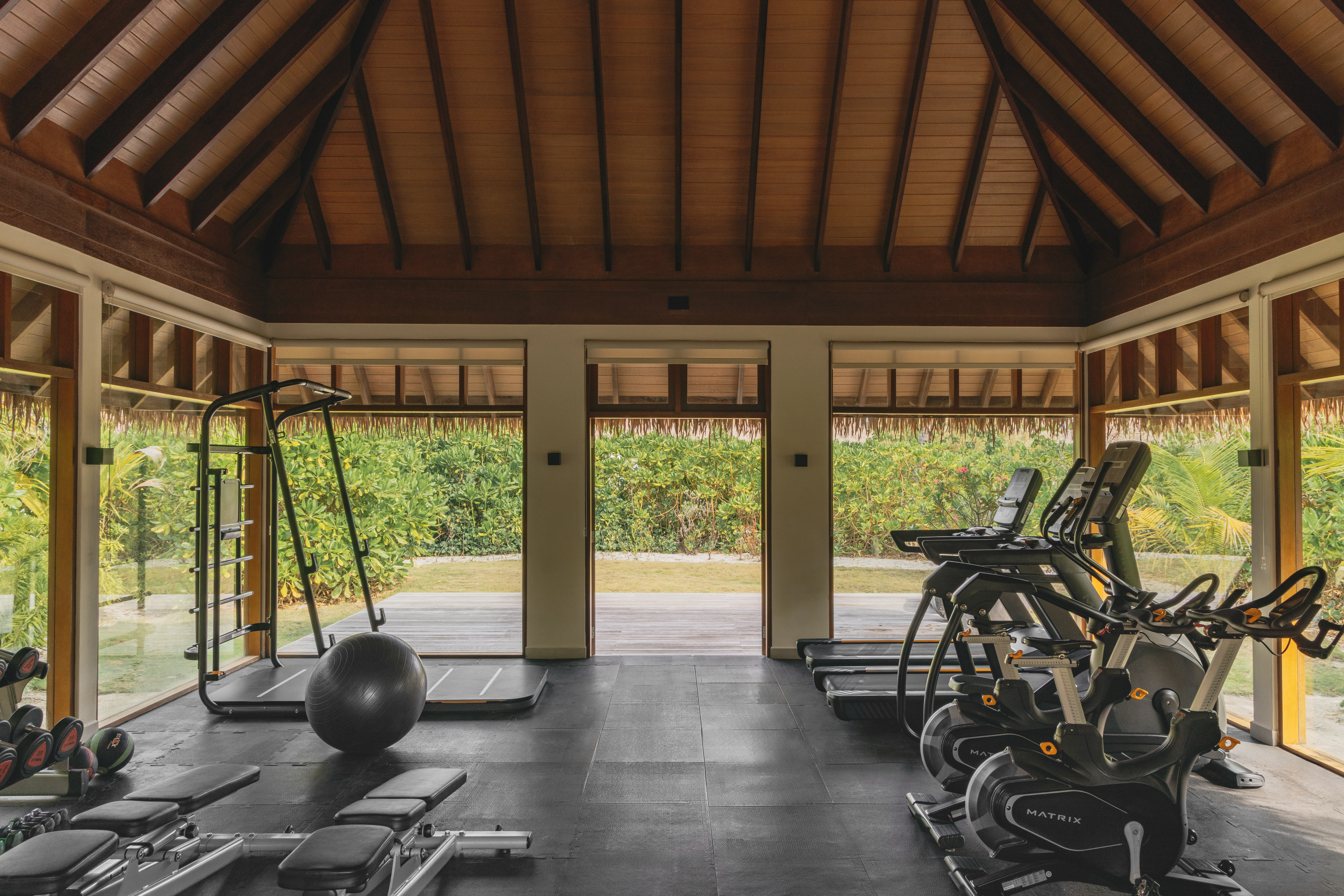 a room with exercise equipment and a large window