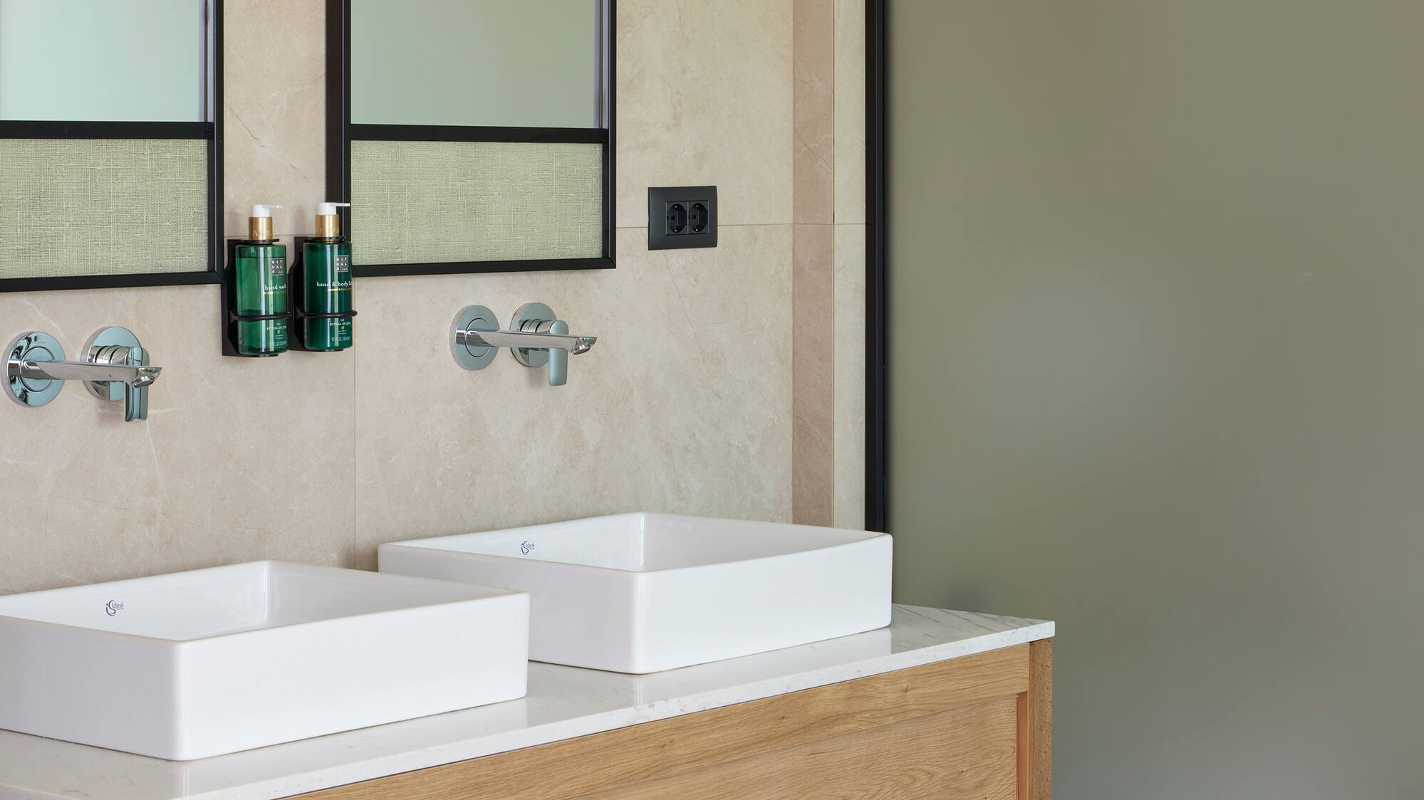 a bathroom with sinks and mirrors