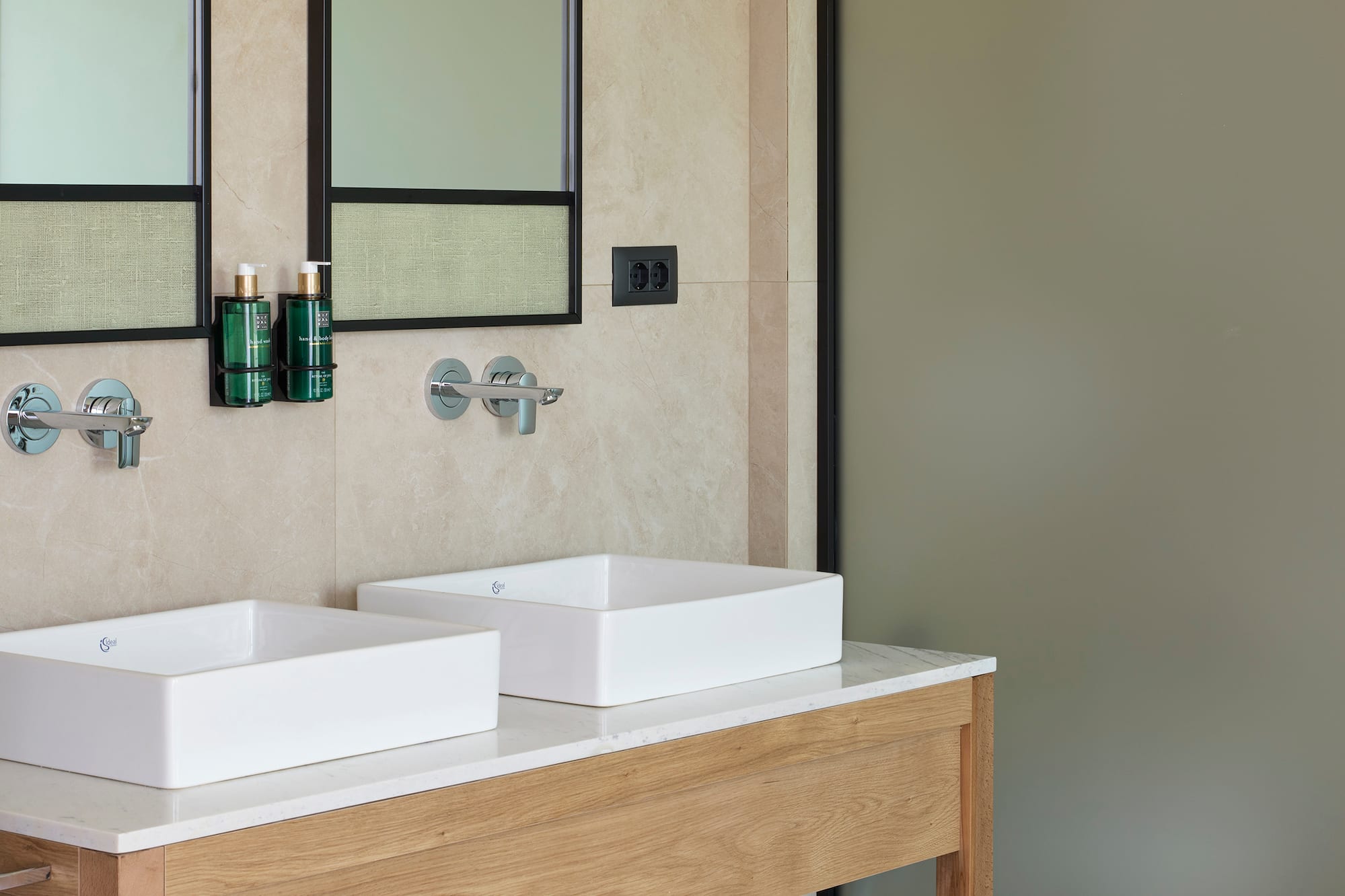 a bathroom with sinks and mirrors