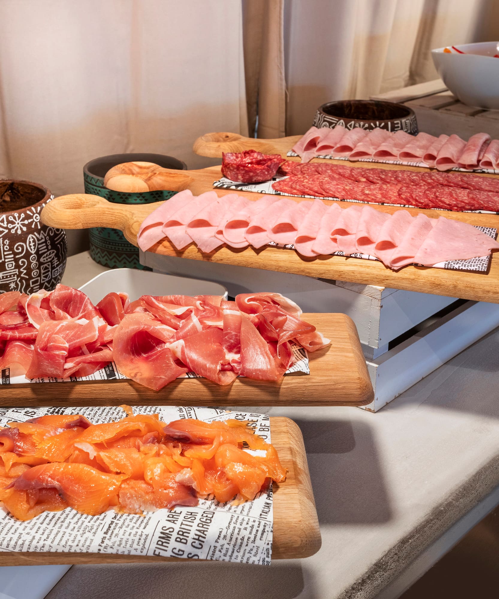 a group of cutting boards with different types of meat on them