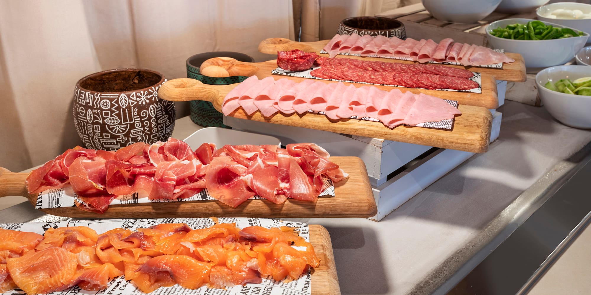 a group of cutting boards with different types of meat on them