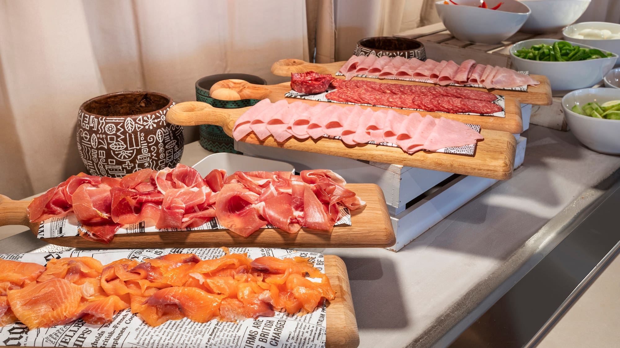 a group of cutting boards with different types of meat on them