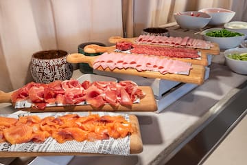 a group of cutting boards with different types of meat on them