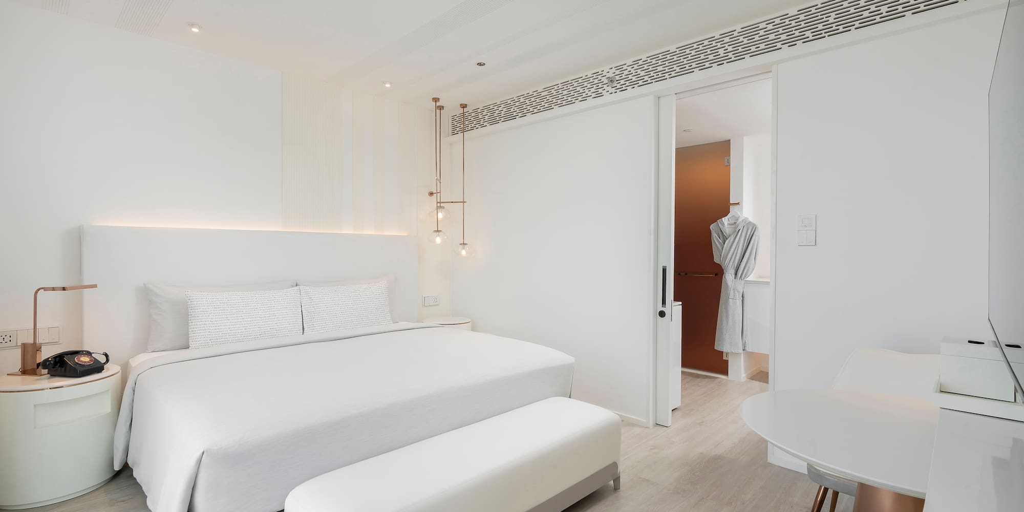 a bedroom with a bed and a table