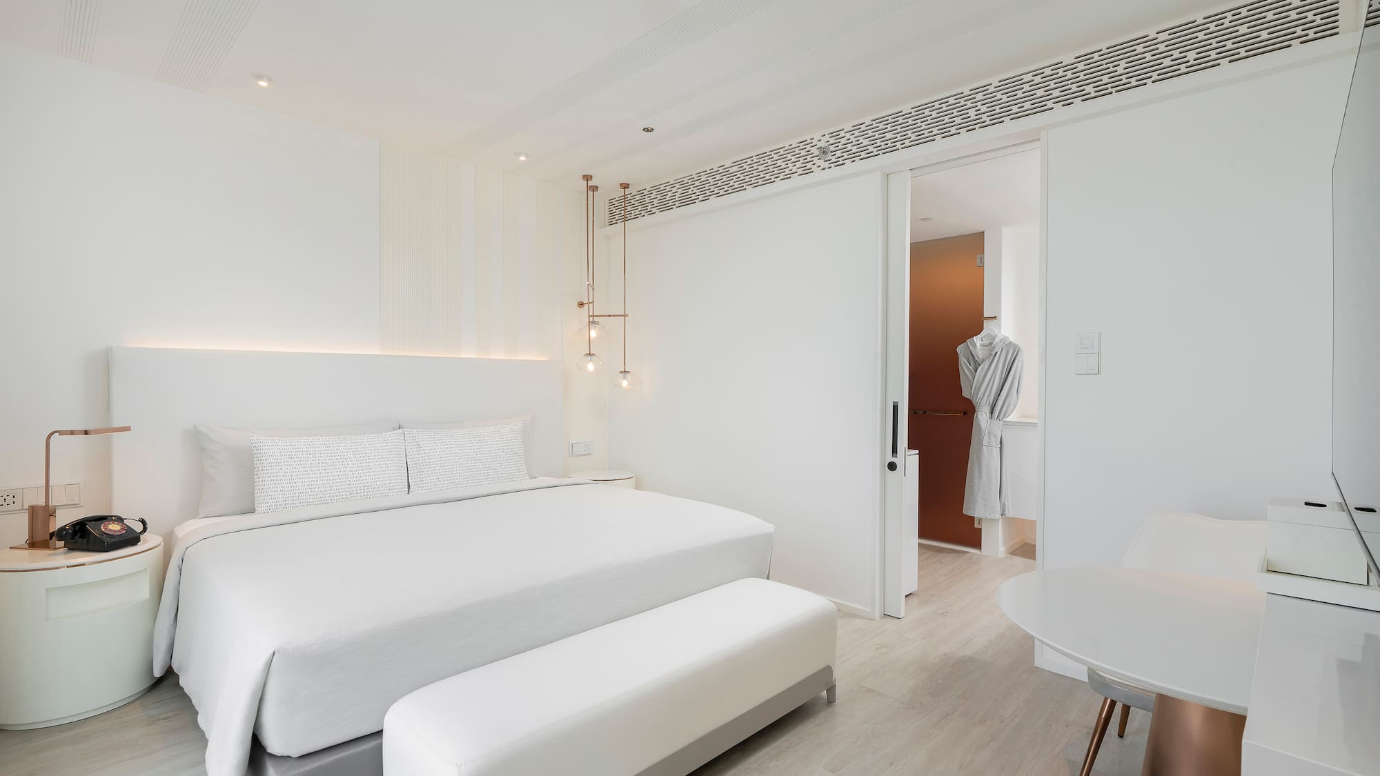 a bedroom with a bed and a table