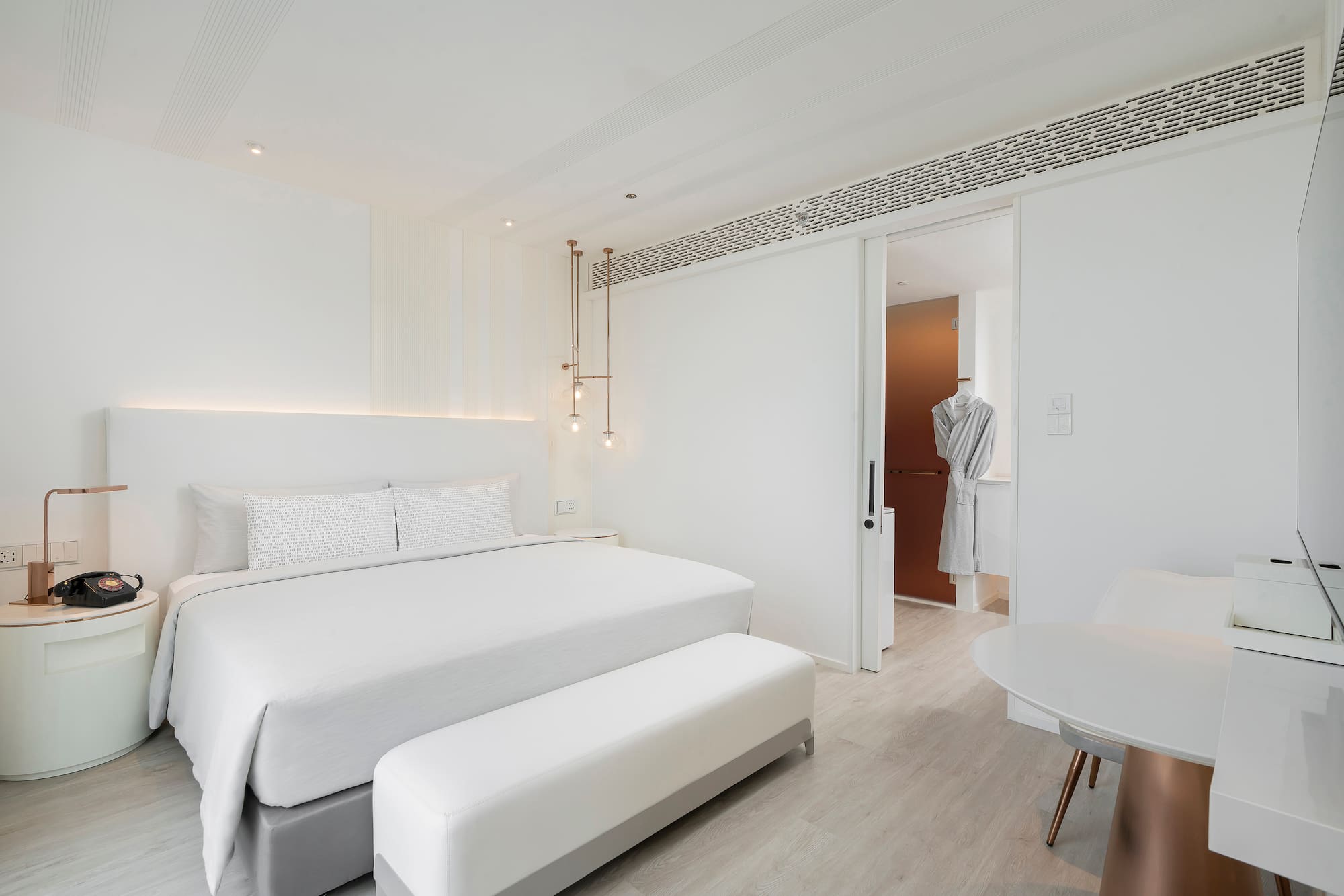 a bedroom with a bed and a table