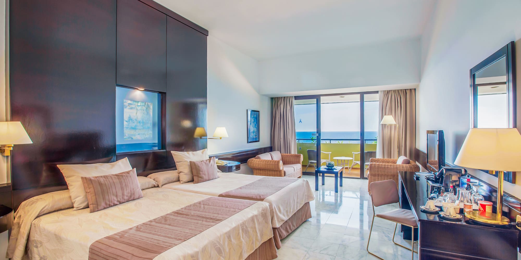 a room with two beds and a television