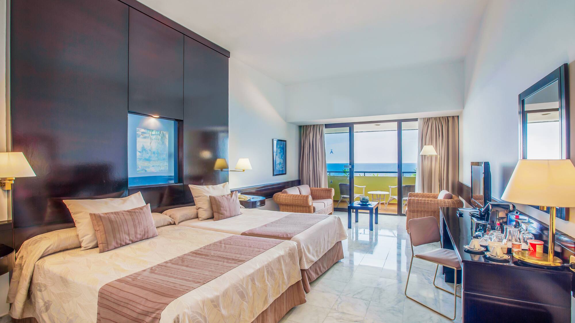 a room with two beds and a television