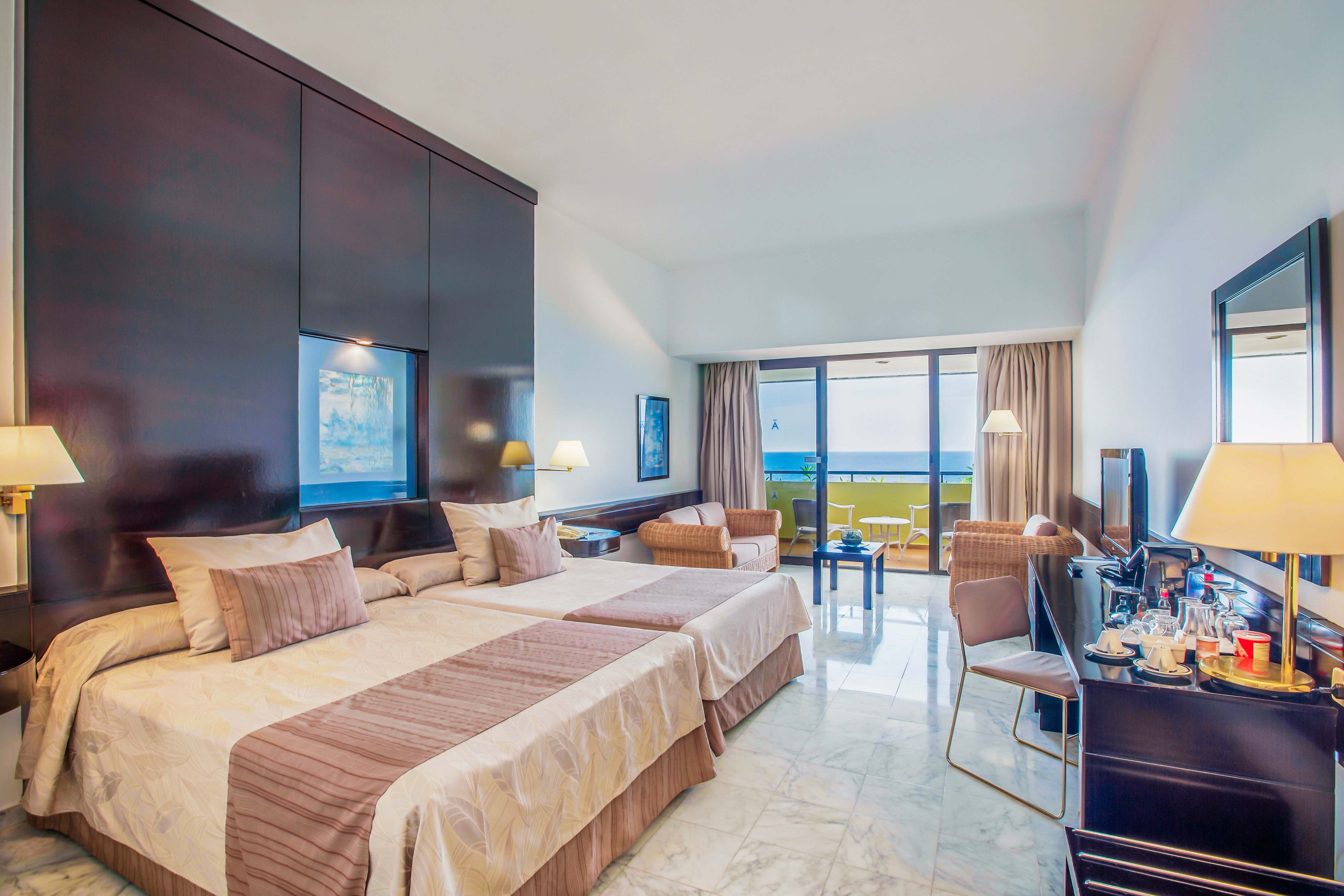 a room with two beds and a television