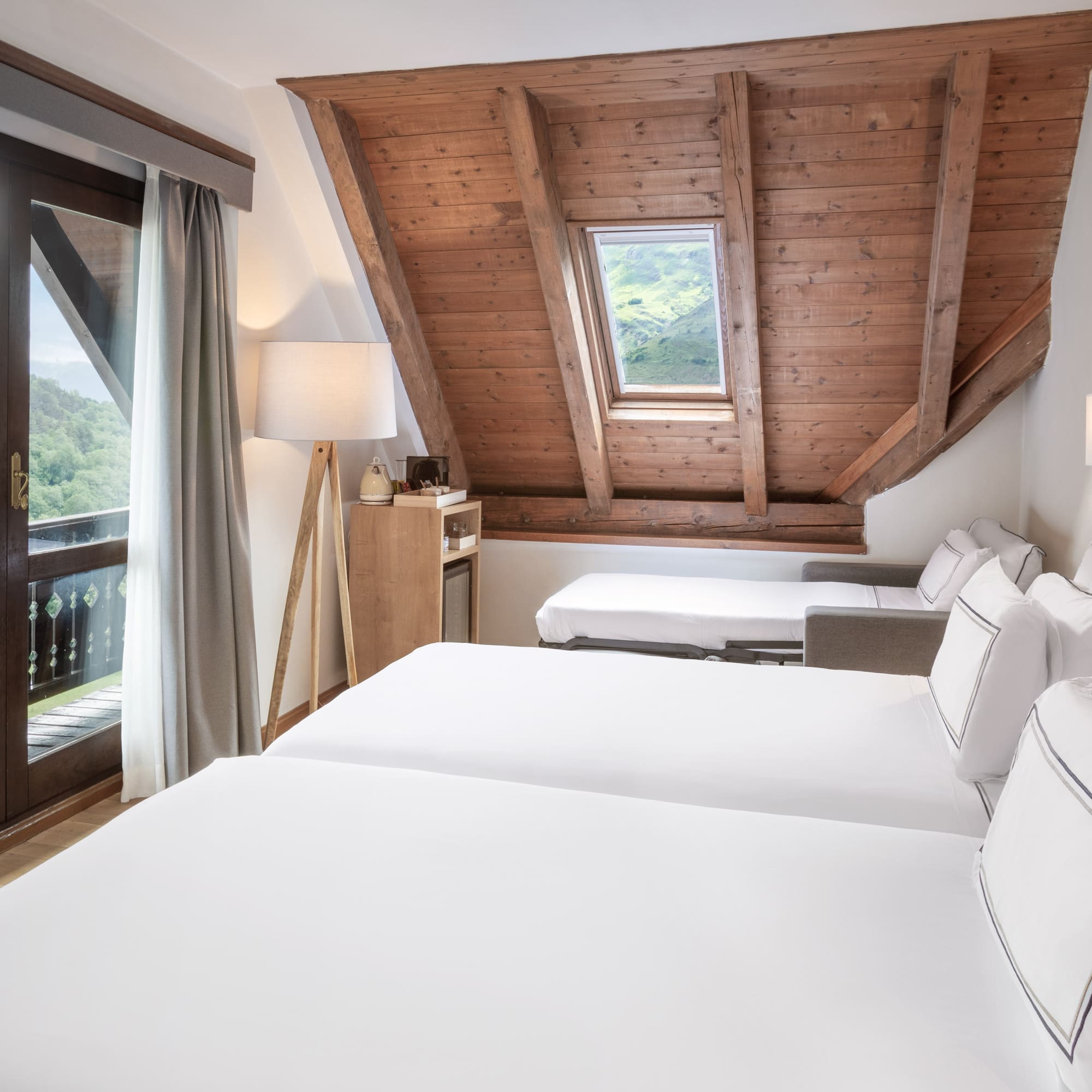 a room with a wooden ceiling and a window