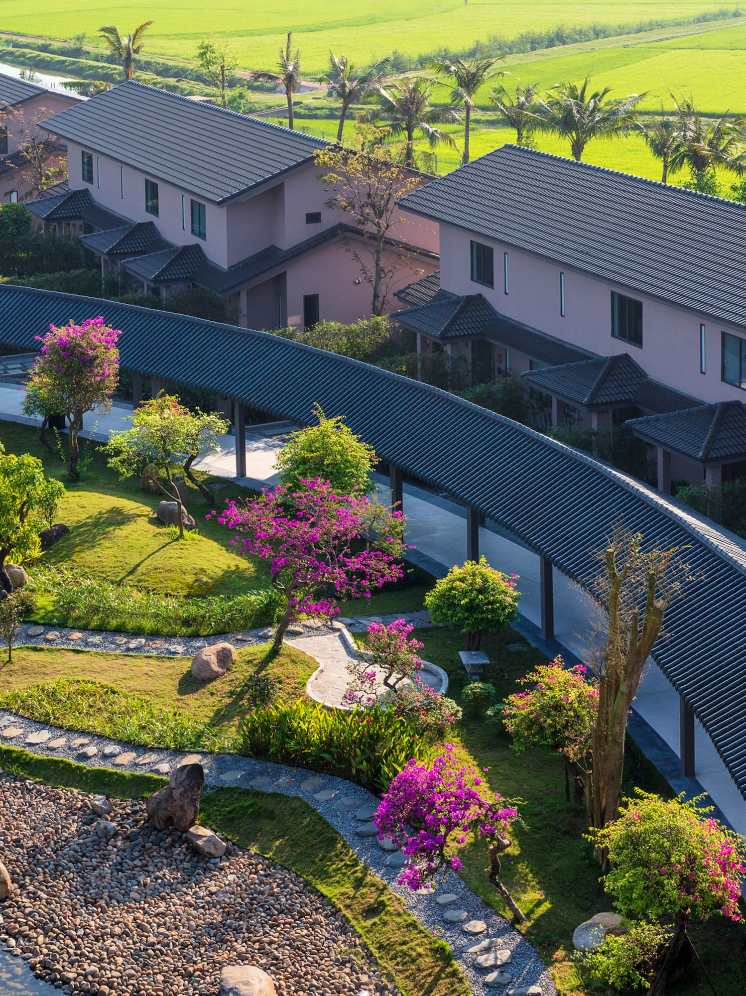 a group of houses with trees and a walkway