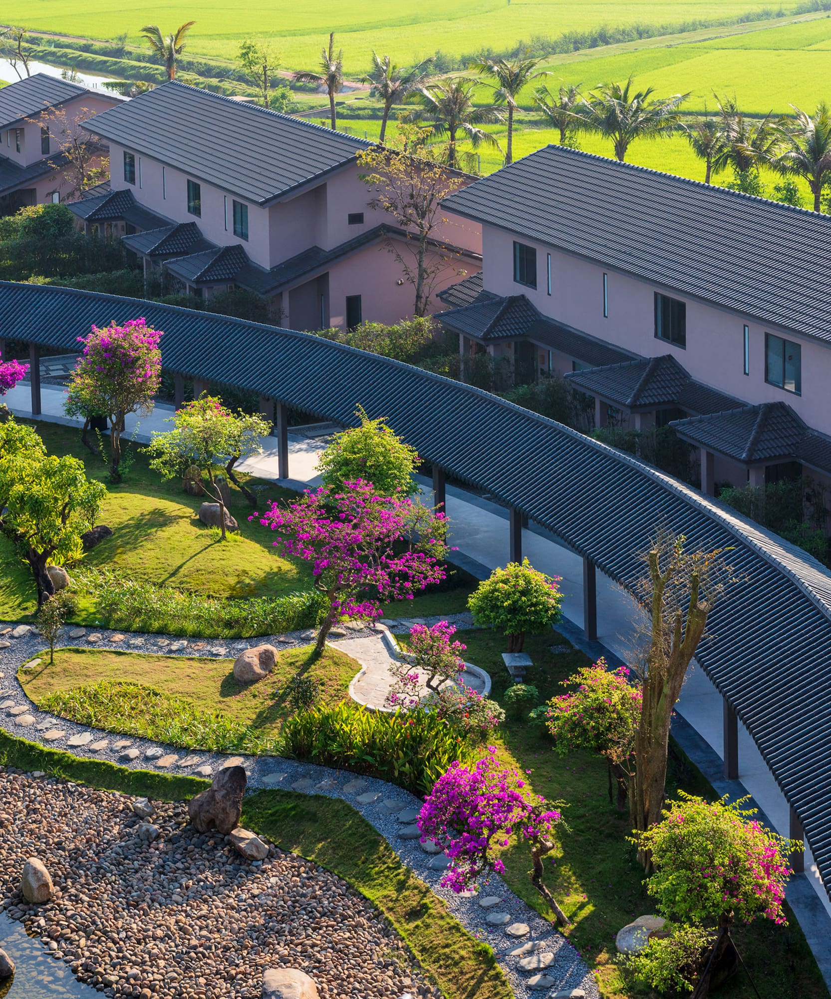 a group of houses with trees and a walkway