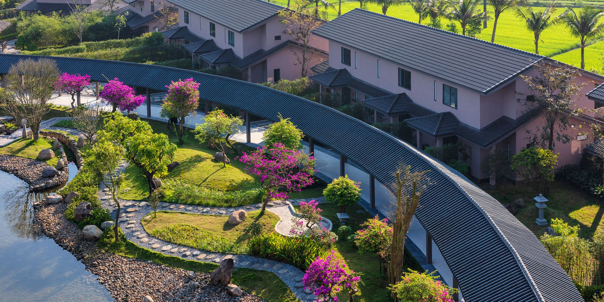 a group of houses with trees and a walkway