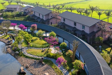 a group of houses with trees and a walkway