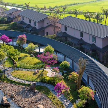 a group of houses with trees and a walkway