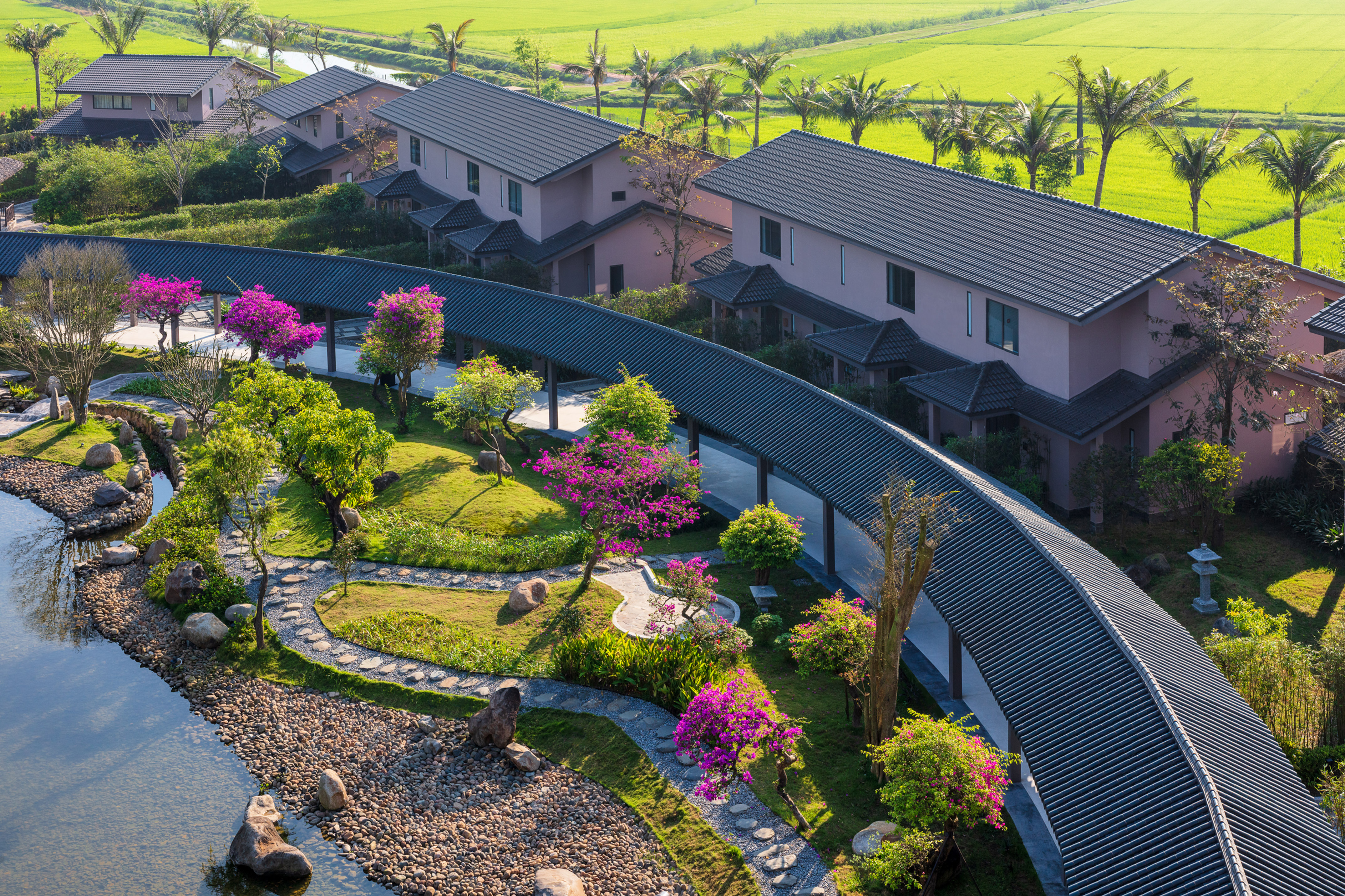 a group of houses with trees and a walkway