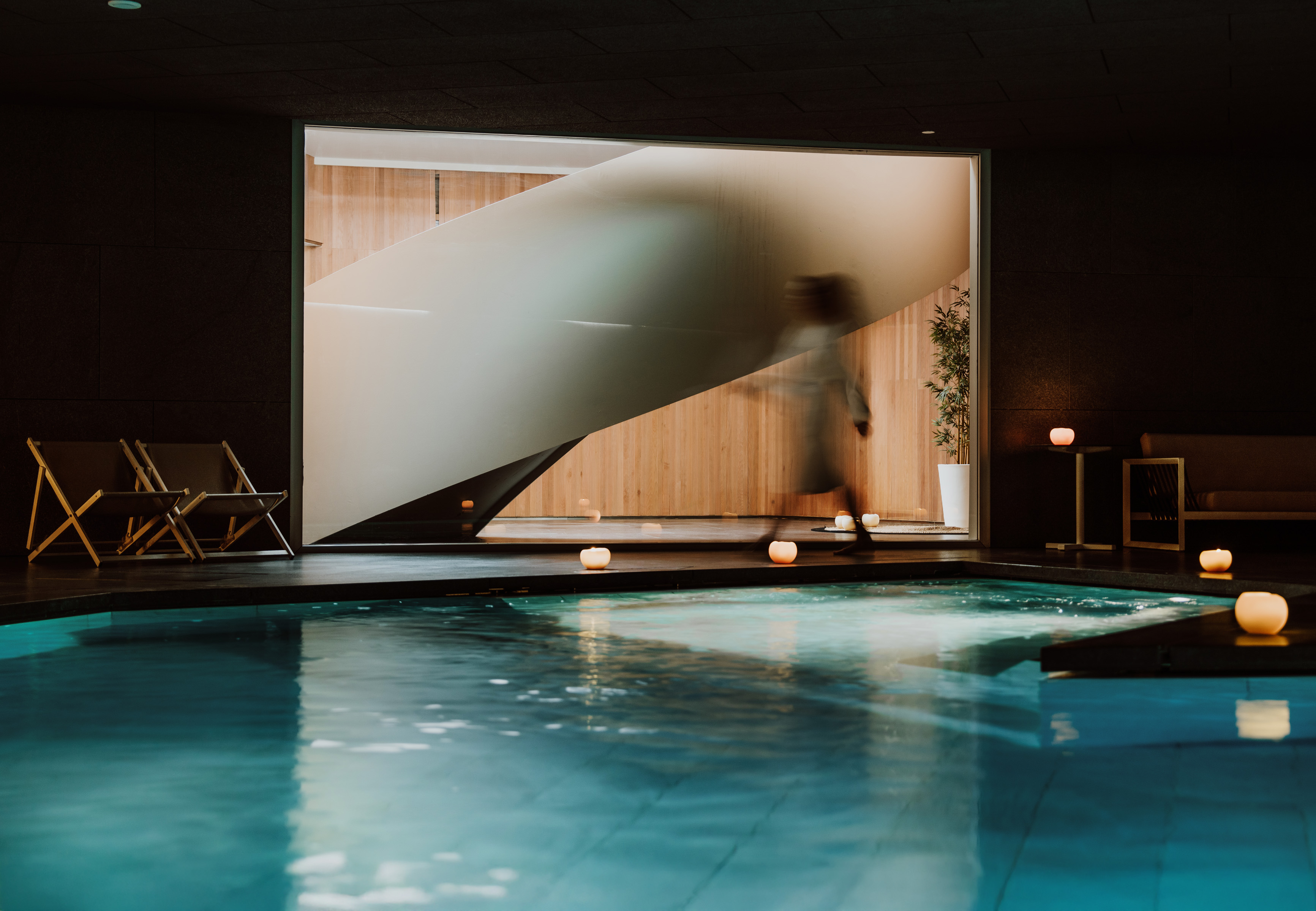 a person walking into a swimming pool