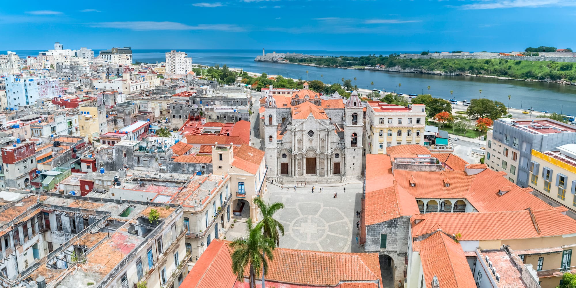 a city with red roofs and a body of water