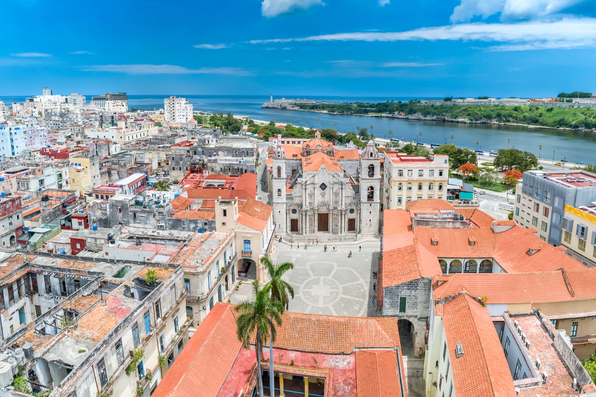 a city with red roofs and a body of water
