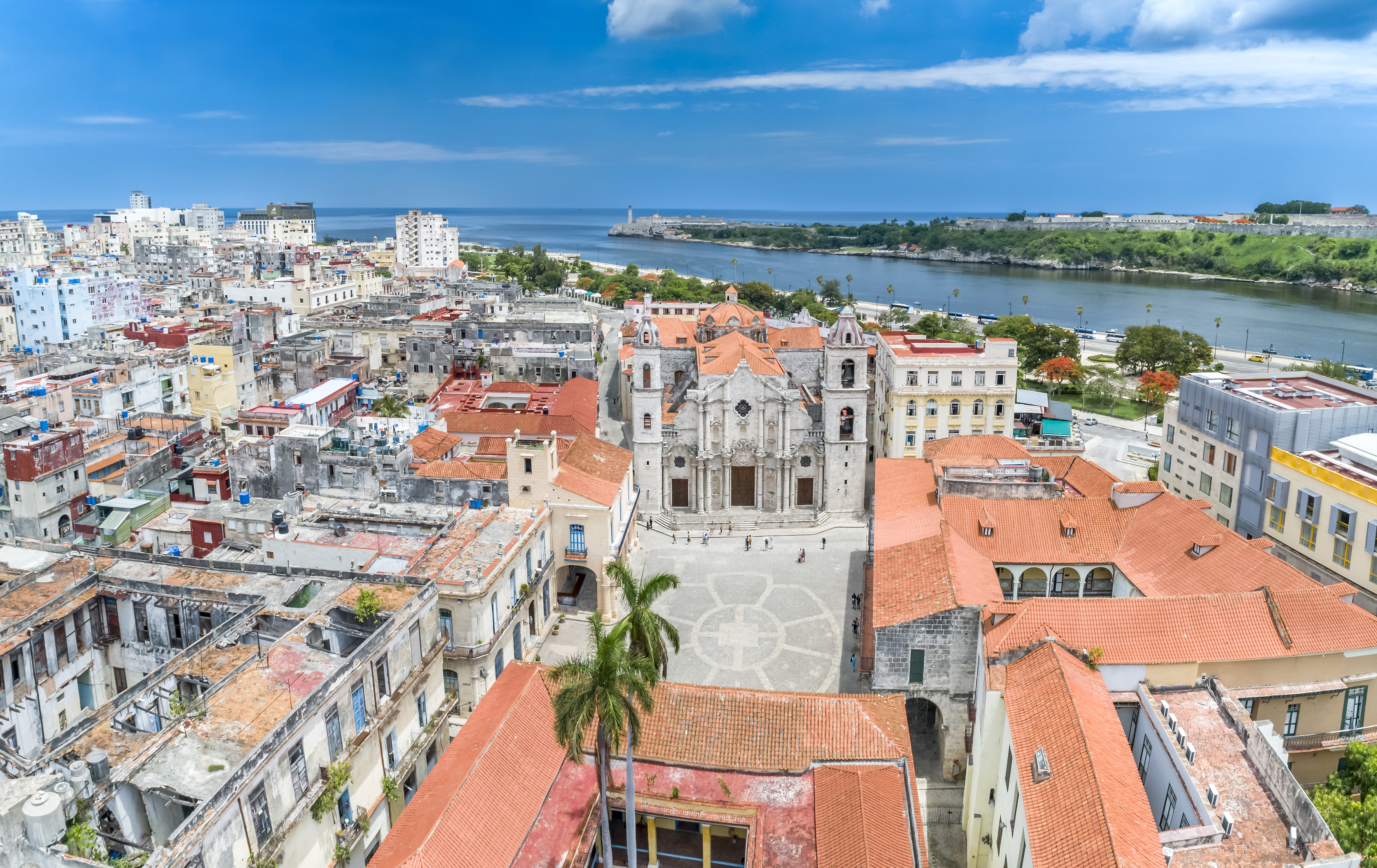 a city with red roofs and a body of water