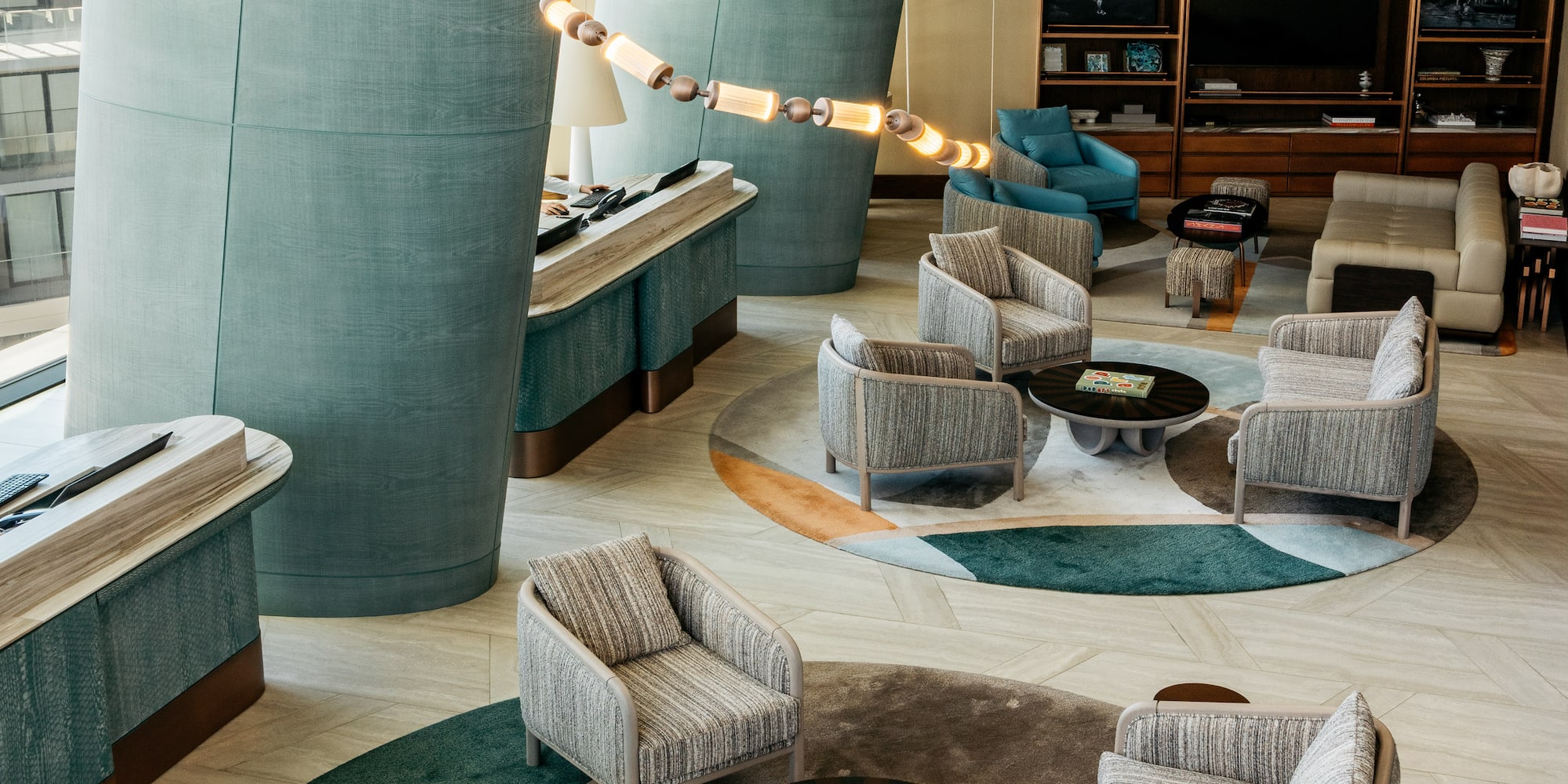 a room with a large column and chairs and a table