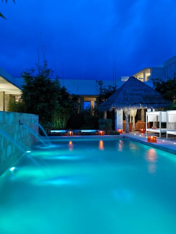 a pool with a fountain in the middle of it
