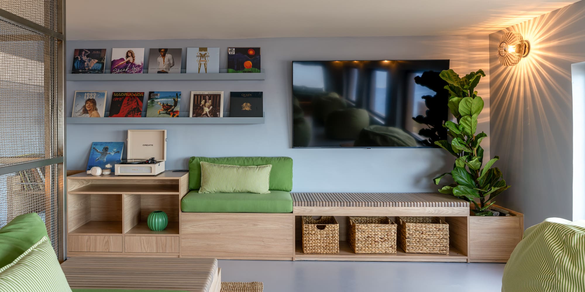 a room with a television and a plant